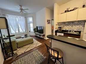 Chicago apartment for rent - A living room with a couch, chair, and television.