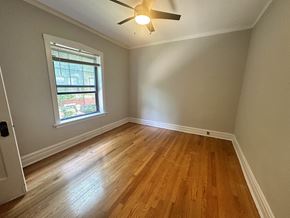 Evanston apartment for rent - an empty bedroom with hardwood floors and a ceiling fan