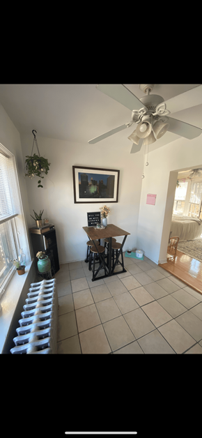 Chicago apartment for rent - a dining room with a table and a ceiling fan