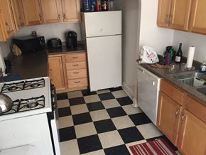 Evanston apartment for rent - a kitchen with a checkered floor and a white refrigerator