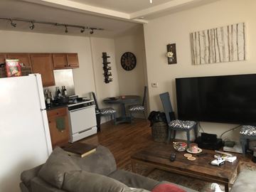 Chicago apartment for rent - A living room with a grey couch and a wooden coffee table.