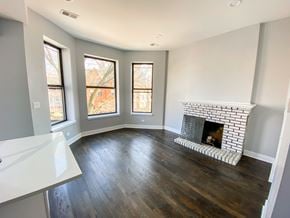 Chicago apartment for rent - A living room with a fireplace and wood flooring.
