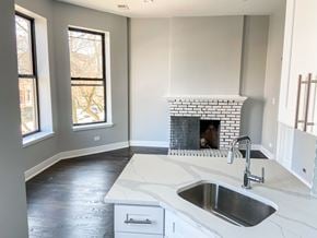 Chicago apartment for rent - A kitchen with a white marble countertop and a fireplace.