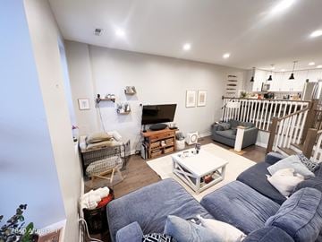 Chicago apartment for rent - A living room with a grey sofa and a white coffee table.