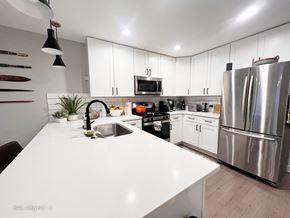 Chicago apartment for rent - A modern kitchen with a white countertop and stainless steel appliances.
