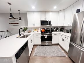 Chicago apartment for rent - A modern kitchen with white cabinets and stainless steel appliances.