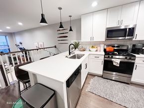 Chicago apartment for rent - A modern kitchen with a white island and stainless steel appliances.