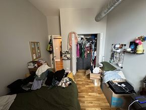 Chicago apartment for rent - A room with a bed, a wardrobe and a desk.