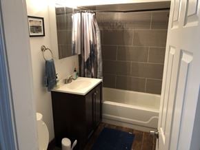 Chicago apartment for rent - A bathroom with a sink, toilet and shower.