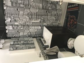 Chicago apartment for rent - A black and white bathroom with a Bears logo on the wall.