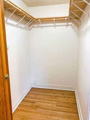 Chicago apartment for rent - an empty closet with white walls and a wooden floor