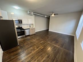 Chicago apartment for rent - A kitchen with a black fridge, microwave, and stove.