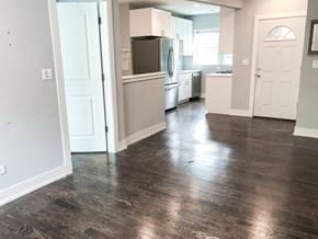 Chicago apartment for rent - A kitchen with a white door and a white fridge.