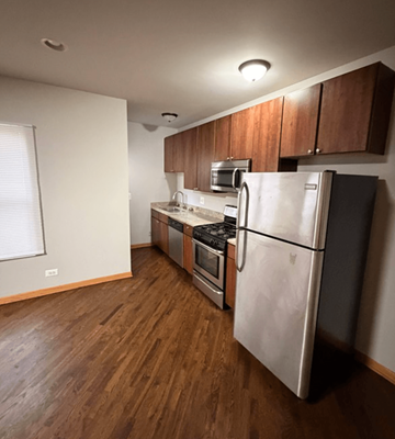 Chicago apartment for rent - A kitchen with a refrigerator, oven, and microwave.