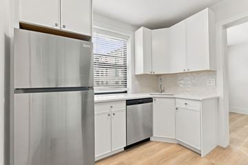 Evanston apartment for rent - A kitchen with white cabinets and a stainless steel refrigerator.