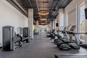 Cleveland apartment for rent - A gym with a row of treadmilers and elliptical machines.