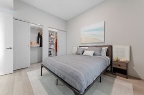 Cleveland apartment for rent - A bedroom with a bed, nightstand, and a painting on the wall.