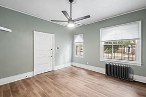 Denver apartment for rent - A room with a ceiling fan and a window with blinds.