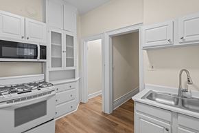 Denver apartment for rent - A kitchen with white cabinets and appliances.