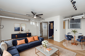 Denver apartment for rent - A living room with a blue couch and a coffee table.