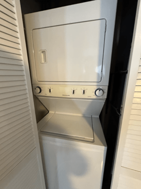 Chicago apartment for rent - A white dishwasher is shown in a narrow space between two walls.