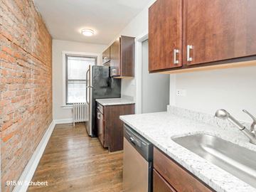 Chicago apartment for rent - a kitchen with a sink and a refrigerator and a window