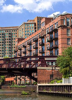 Chicago apartment for rent - a bridge over a river in front of tall buildings