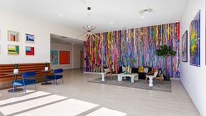 Denver apartment for rent - the lobby of a building with a colorful wall and furniture