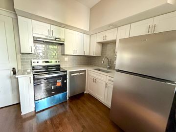 Chicago apartment for rent - A kitchen with a stove, sink, and refrigerator.