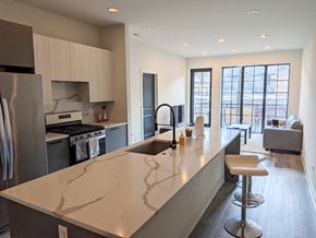 Chicago apartment for rent - A modern kitchen with a marble countertop and stainless steel appliances.