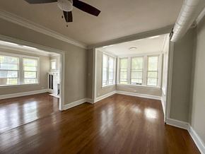 Chicago apartment for rent - A room with wooden floors and a ceiling fan.