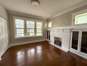 Chicago apartment for rent - A room with a fireplace and a window.