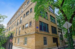 Chicago apartment for rent - a large brick building with a tree in front of it
