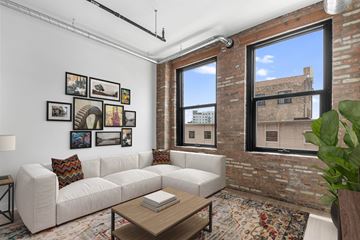 Chicago apartment for rent - A living room with a white couch and a coffee table.