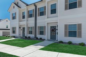 Oxford apartment for rent - the front of a white house with a sidewalk and grass