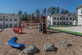 Oxford apartment for rent - an empty playground with rocks and slides in front of apartment buildings
