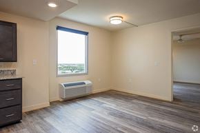 New Orleans apartment for rent - an empty living room with a radiator and a window