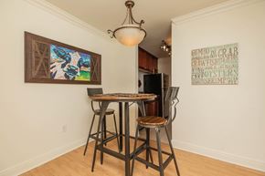 Baton Rouge apartment for rent - A dining room with a table and chairs and a painting on the wall. at The Cove at State Street Apartments, Baton Rouge