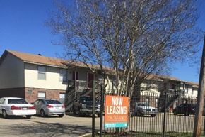 Baton Rouge apartment for rent - a now leasing sign in front of a house