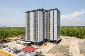 New Orleans apartment for rent - a high rise apartment building in front of a parking lot