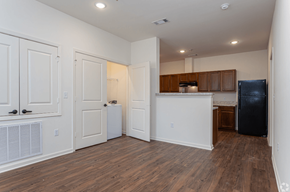 Ville Platte apartment for rent - an empty living room and kitchen with white walls and wood flooring