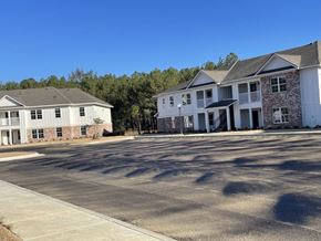 Tupelo apartment for rent - an empty parking lot in front of two apartment buildings