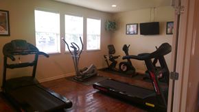 Lafayette apartment for rent - a home gym with exercise equipment in a living room
