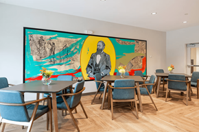 Baton Rouge apartment for rent - A dining room with a large painting on the wall and blue chairs.