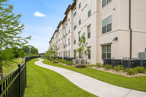 Baton Rouge apartment for rent - A long building with a green lawn in front.