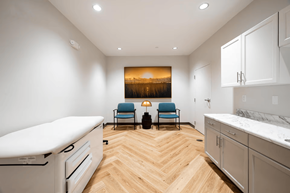 Baton Rouge apartment for rent - A modern kitchen with a wooden floor and a painting of a sunset on the wall.