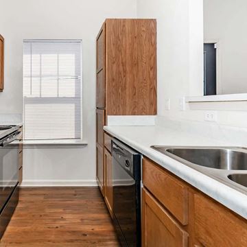 Oxford apartment for rent - a kitchen with wooden cabinets and a sink and a window