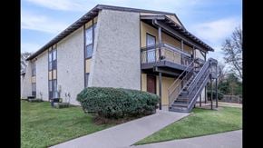 Shreveport apartment for rent - A two-story building with a balcony on the second floor.
