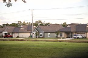 Tupelo apartment for rent - a row of houses on a street in front of a field
