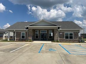 Sterlington apartment for rent - A building with a parking lot in front of it.